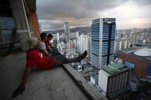 Men rest after salvaging metal on the 30th floor of the "Tower of David" skyscraper in Caracas February 3, 2014