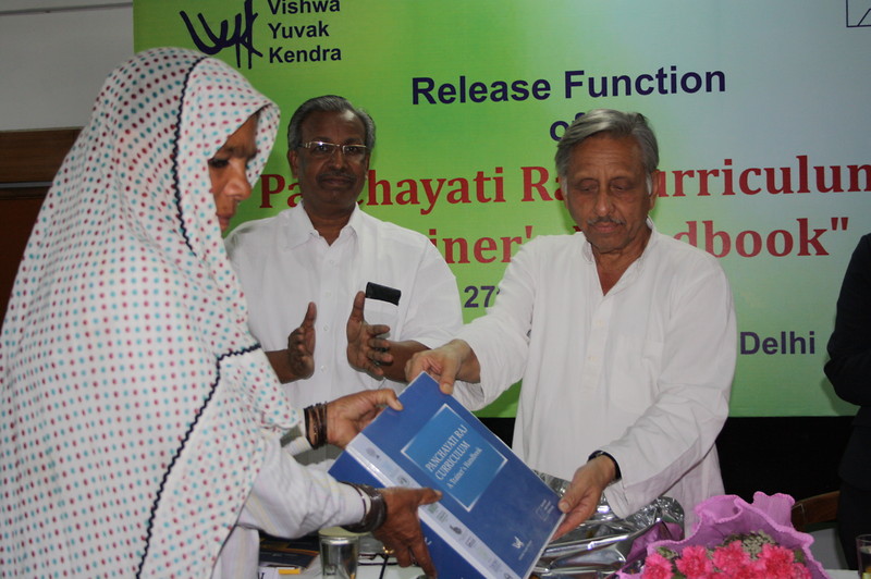 Mani Shankar Aiyar handing over a copy to a village council member