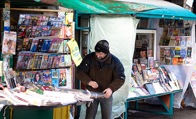 Ein Mann steht an einem Kiosk in Bulgarien und sortiert die Zeitungen. | Foto: florianplag/Flickr