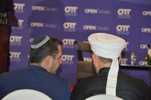 A representative from the Jewish community in discussion with a delegate from the Muslim community