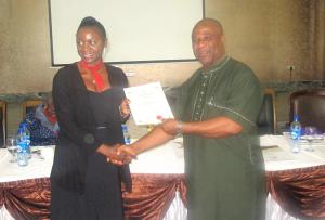 A graduate of the leadership-seminar of the Centre-LSD is presented his certificate at the yearly conference at 18 March, 2015 in Abuja, Nigeria.