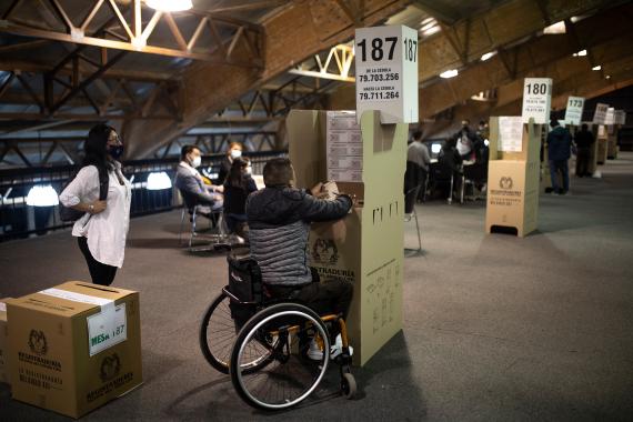 A man in a wheelchair casts his vote during legislative elections in Bogota, Colombia, Sunday, March 13, 2022. Colombians went to the polls to renew Congress, and also to choose presidential candidates from three political coalitions whose outcome will be key for the next presidential election on May 29. (AP Photo/Ivan Valencia) 