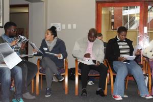 Attendees reading the IEC observer training manual and engaging each other on it