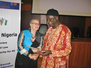 Head of Konrad-Adenauer-Foundation in Nigeria, Mrs. Hildegard Behrendt-Kigozi, presents the certificate of participation to Bassey Ekpenyong, Clerk of Cross River State House of Assembly.