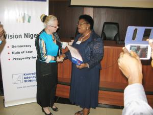 Head of Konrad-Adenauer-Foundation in Nigeria, Mrs. Hildegard Behrendt-Kigozi, presents the certificate of participation to Hon. Lady Elizabeth Edem Ironbar of Cross River State House of Assembly.