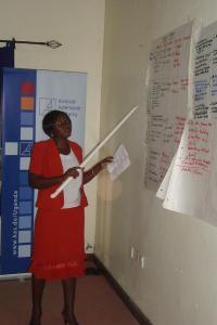 Participant presenting group work results in Arua