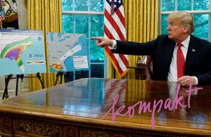 U.S. President Donald Trump talks about Hurricane Michael next to maps and projections on the storm during a meeting in the Oval Office at the White House.