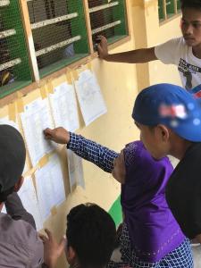 Voters browsing their names in the voters' list