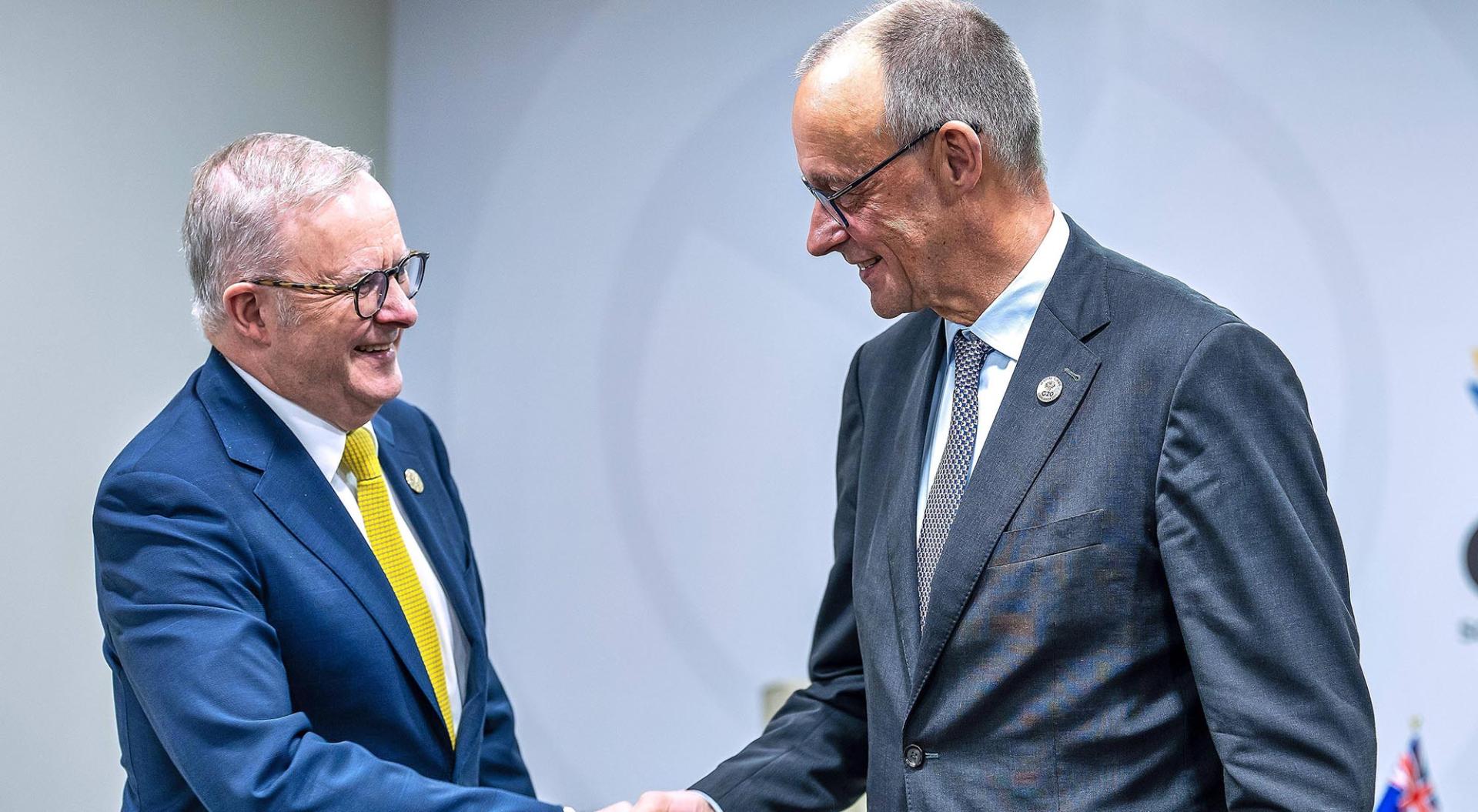 Johannesburg, South Africa, 22/11/2025; Expo Centre; G20 Summit: Prime Minister of Australia Anthony Albanese and German Chancellor Friedrich Merz CDU shake hands at a bilateral meeting.